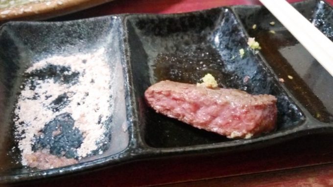 焼いたいい肉を塩・わさびで食べようとしているの図